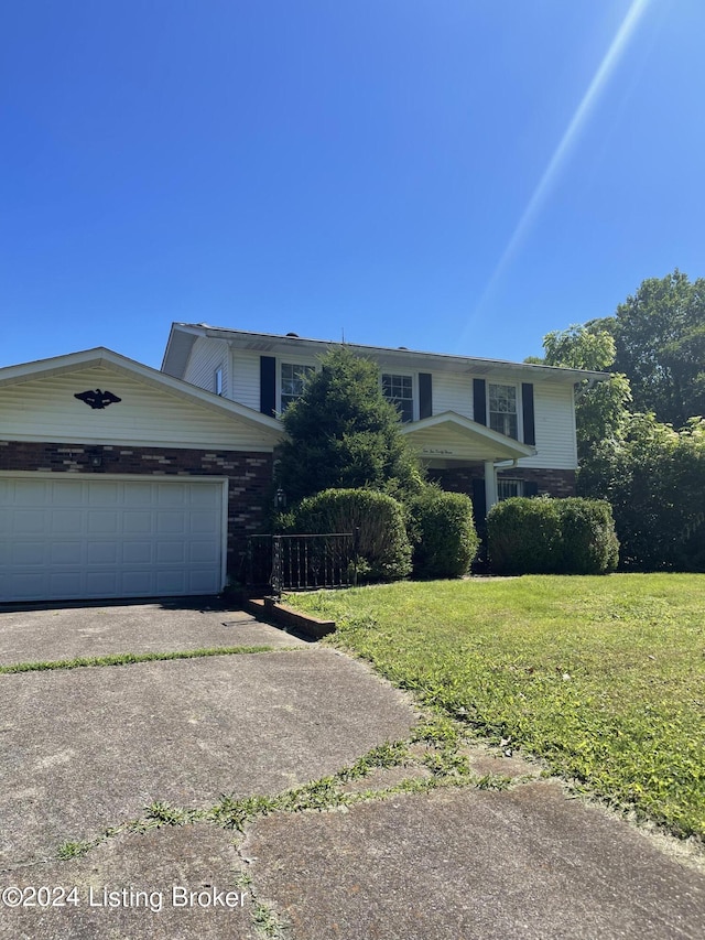 view of front of house with a garage and a front lawn