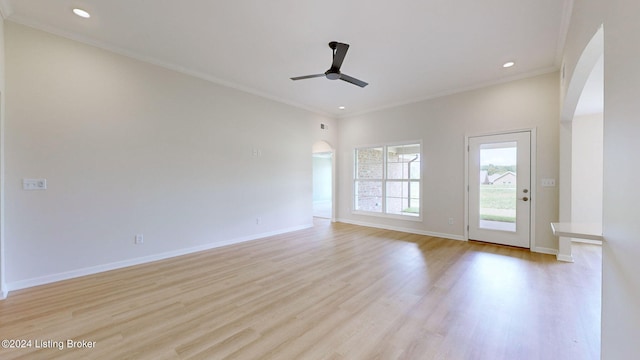 interior space featuring ceiling fan, ornamental molding, and light wood-type flooring