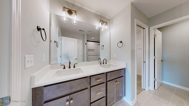 bathroom with tile patterned flooring and vanity