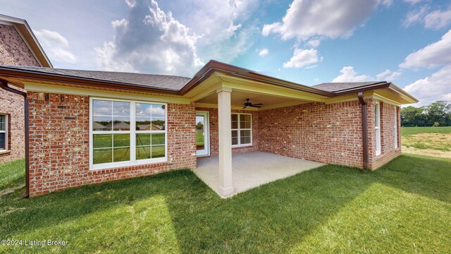 back of property with a patio area and a lawn