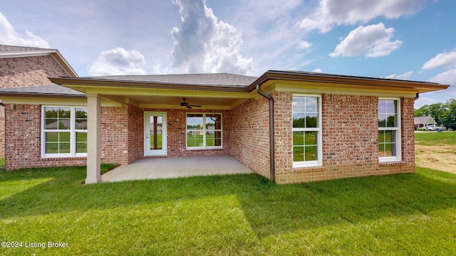 rear view of property featuring a patio, ceiling fan, and a lawn