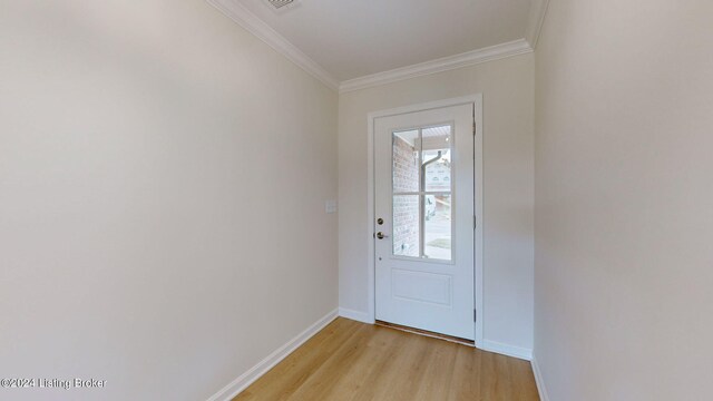 doorway with light wood-type flooring and ornamental molding