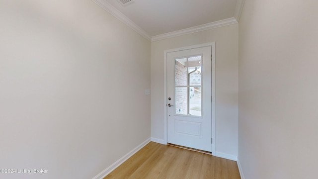 doorway with ornamental molding and light wood-type flooring