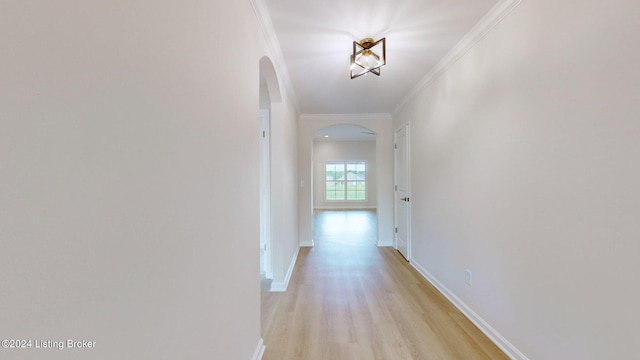 hall featuring ornamental molding and light hardwood / wood-style flooring