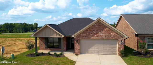 view of front facade with a front yard, a porch, and a garage