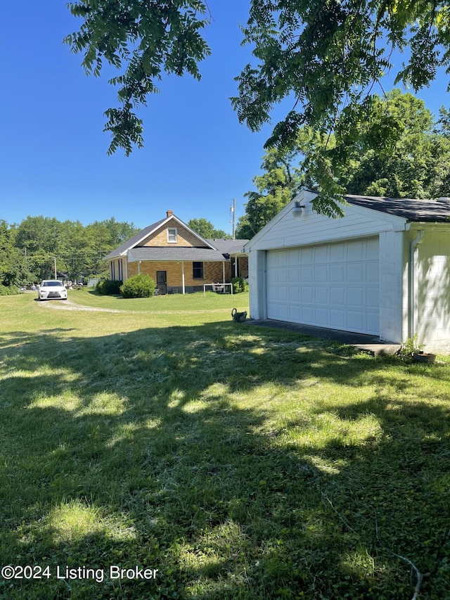 view of yard with a garage and an outdoor structure