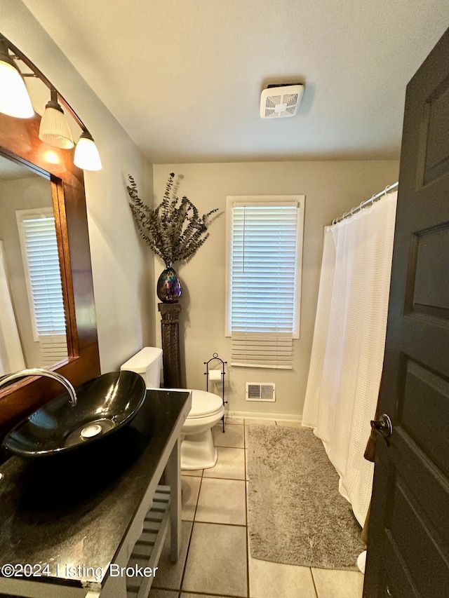 bathroom featuring vanity, tile patterned floors, and toilet