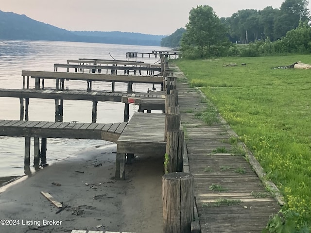 view of dock with a water and mountain view