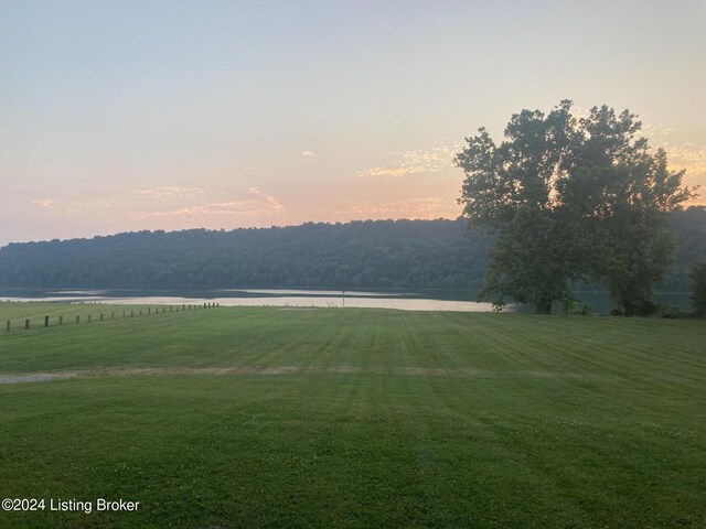 view of home's community featuring a yard and a water view