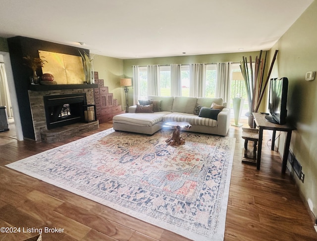 living room with dark hardwood / wood-style floors and a fireplace