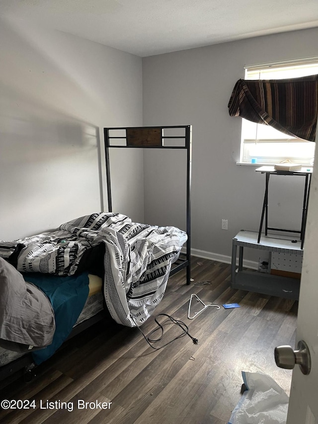 bedroom featuring dark wood-type flooring