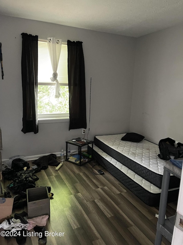 bedroom featuring wood-type flooring and a textured ceiling