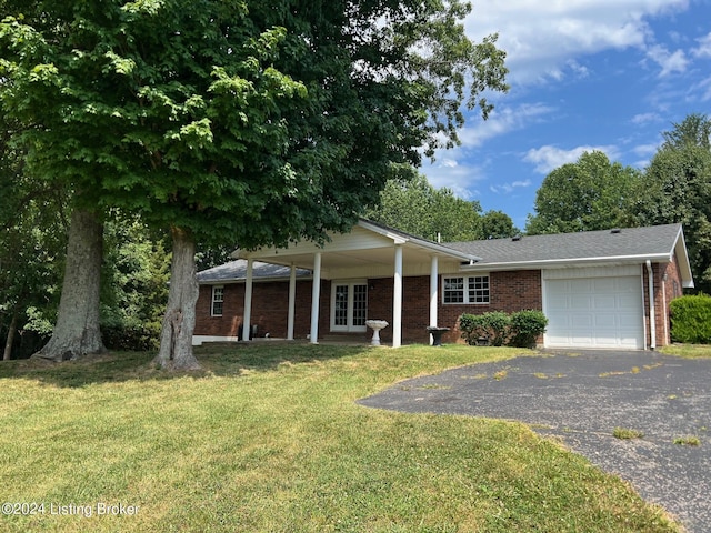 ranch-style home with a front yard, french doors, brick siding, aphalt driveway, and a garage