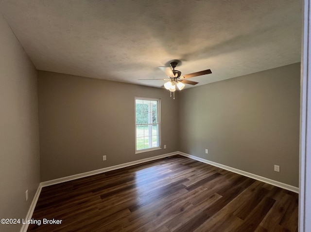 unfurnished room featuring a ceiling fan, a textured ceiling, baseboards, and dark wood finished floors
