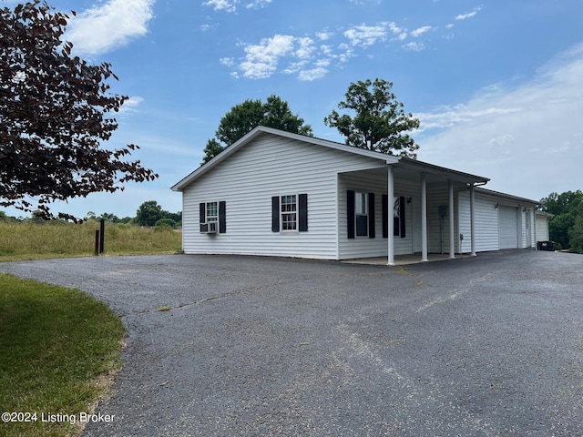 view of front of home with cooling unit and a garage