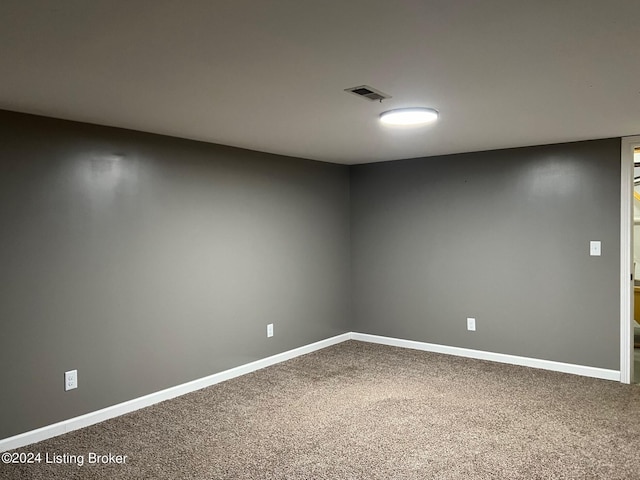 empty room featuring baseboards, visible vents, and carpet flooring