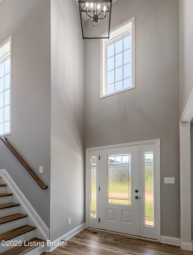 14023 Grandshire Way, Louisville, KY 40245 - entryway featuring a towering ceiling, a chandelier, wood finished floors, stairs, and baseboards