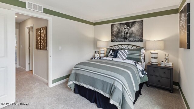 bedroom with light colored carpet