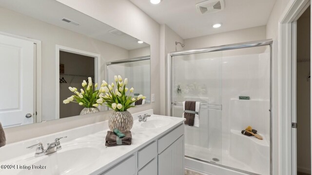 bathroom featuring vanity and an enclosed shower