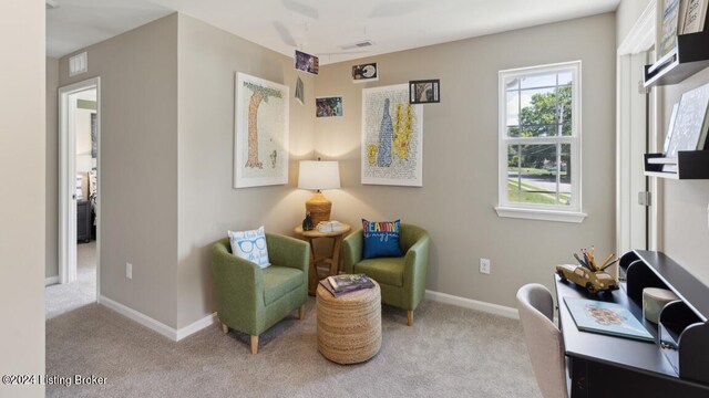 living area with light carpet