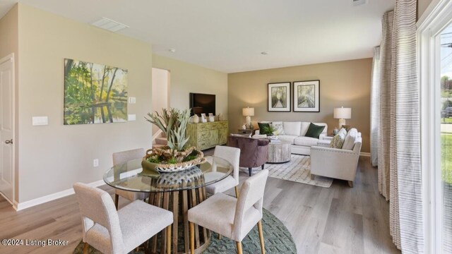 dining space with light hardwood / wood-style floors