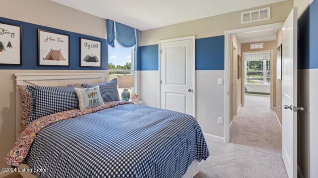 bedroom with light colored carpet