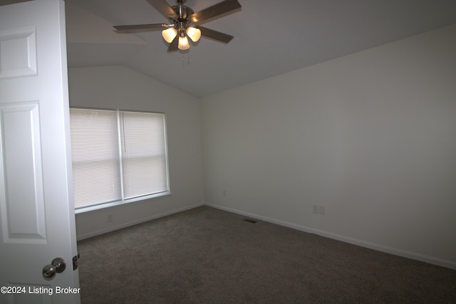 carpeted spare room featuring ceiling fan and lofted ceiling