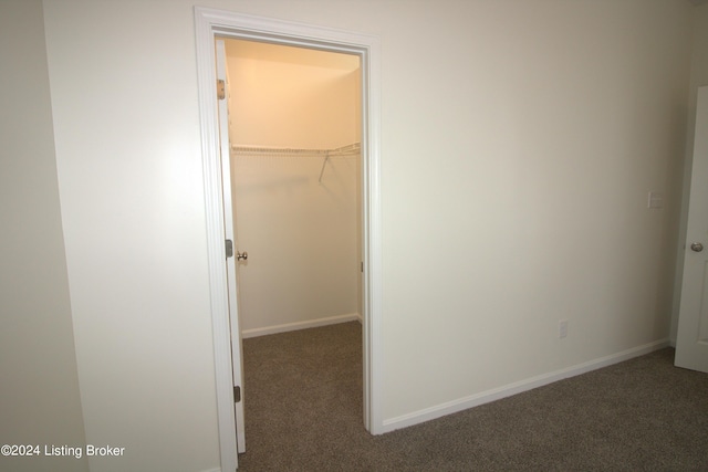 interior space with dark colored carpet