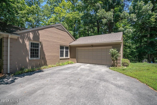 view of front of house with a front lawn and a garage