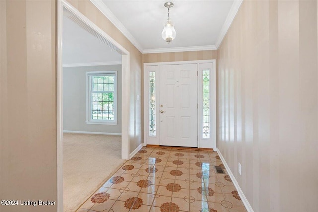 foyer entrance with light carpet and crown molding