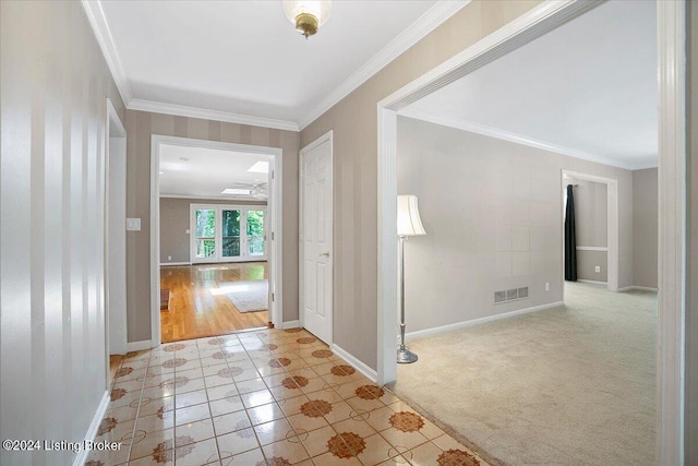 hallway featuring light carpet and ornamental molding