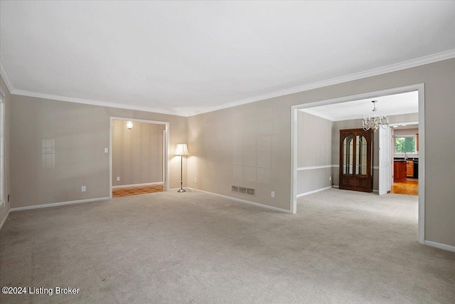 spare room with crown molding, light carpet, and a chandelier