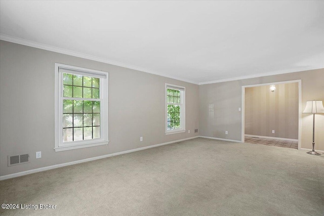 unfurnished room with light colored carpet and ornamental molding