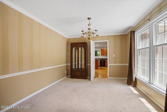 carpeted spare room featuring crown molding and a chandelier