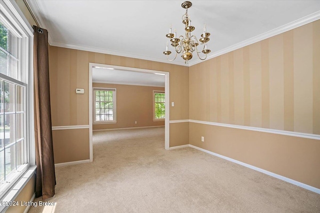 carpeted spare room with crown molding and a chandelier