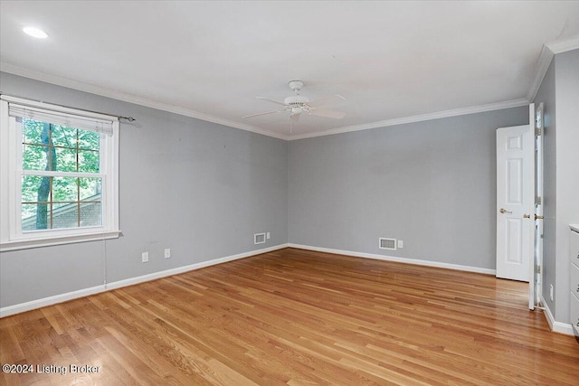 empty room featuring ceiling fan, light hardwood / wood-style floors, and crown molding