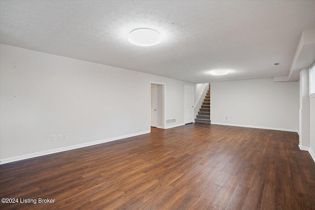 interior space featuring dark hardwood / wood-style flooring and a textured ceiling