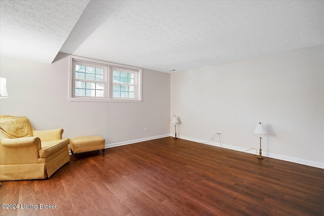 unfurnished room featuring dark hardwood / wood-style floors and a textured ceiling