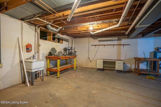 basement featuring a workshop area and sink