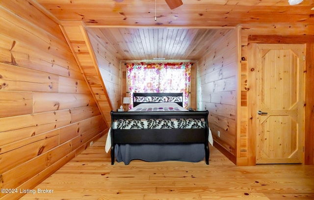 bedroom with wooden ceiling and wooden walls