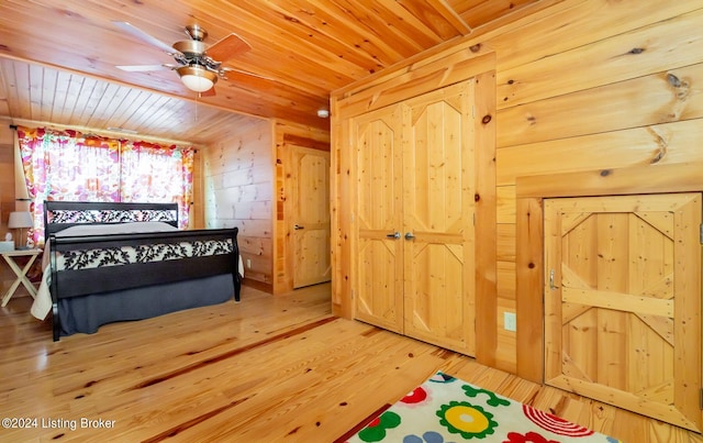 bedroom with wood ceiling, wood-type flooring, and wooden walls