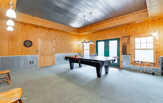 recreation room with wood walls and carpet flooring