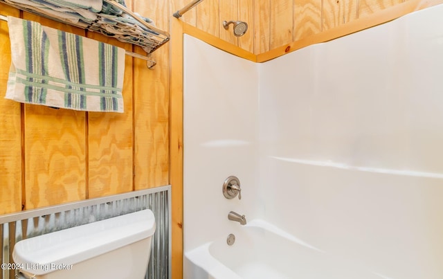 bathroom with bathtub / shower combination and toilet