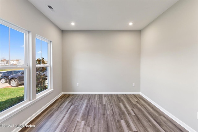 empty room with hardwood / wood-style floors