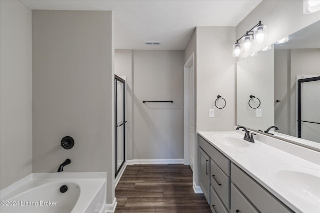 bathroom with vanity, plus walk in shower, and hardwood / wood-style flooring