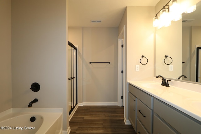 bathroom with vanity, wood-type flooring, and plus walk in shower