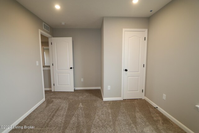 unfurnished bedroom with carpet flooring