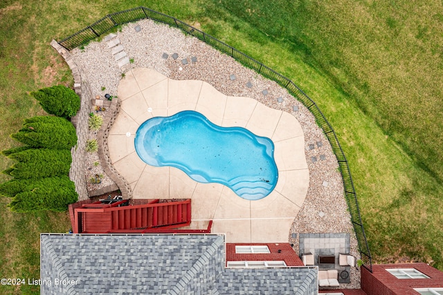 view of pool featuring a patio and a lawn