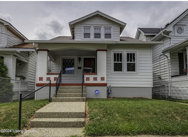 bungalow-style house featuring a front yard and covered porch