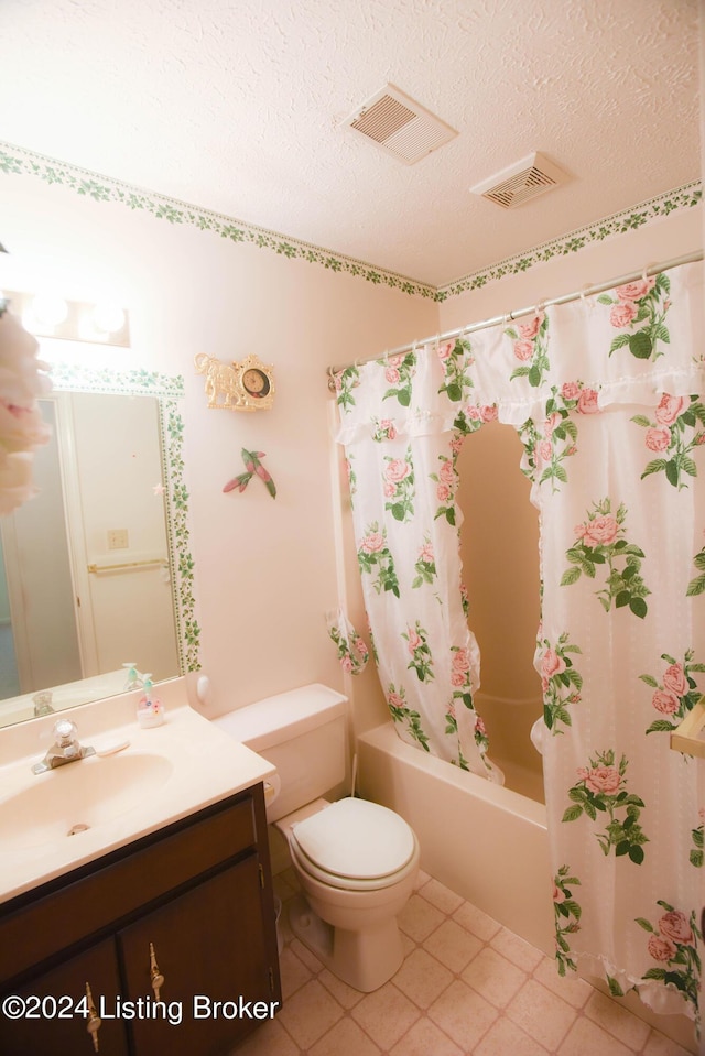 full bathroom with vanity, tile patterned flooring, toilet, a textured ceiling, and shower / tub combo